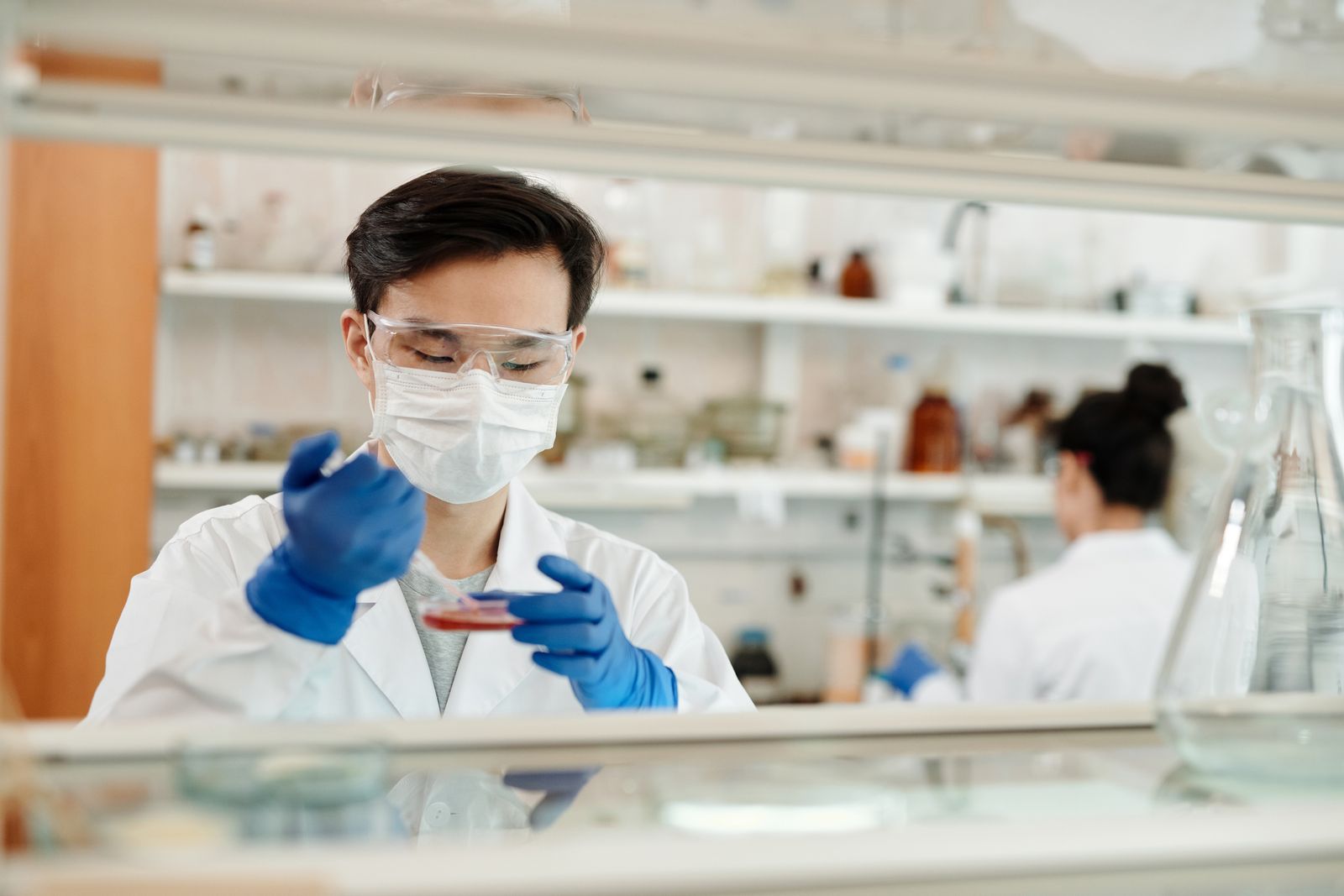 Researcher examining a sample in a laboratory